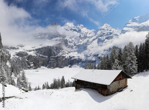 Panoramic winter landscape with frozen lake oeschinen and snow covered mountains, switzerland kandersteg. photo