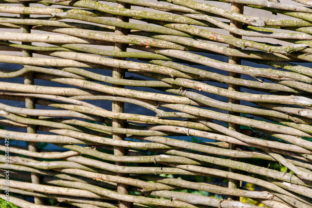 Background of the decorative rustic village wicker fence Background of the decorative rustic village wicker fence