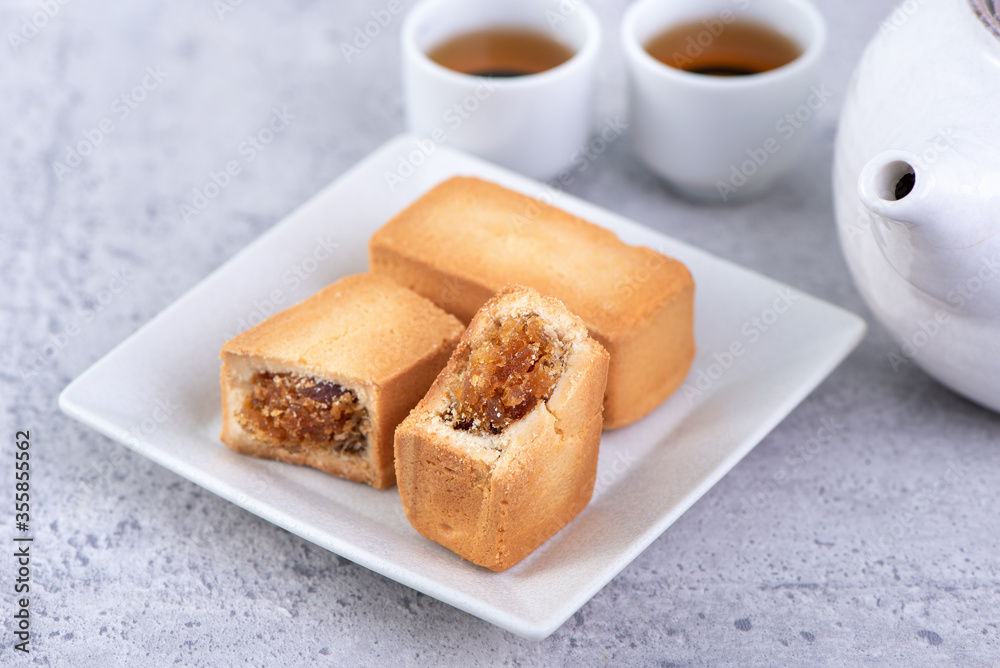 Pineapple cake pastry - Taiwanese famous sweet delicious dessert food with tea, close up, copy space design. Pineapple cake pastry - Taiwanese famous sweet delicious dessert food with tea, close up, copy space design.