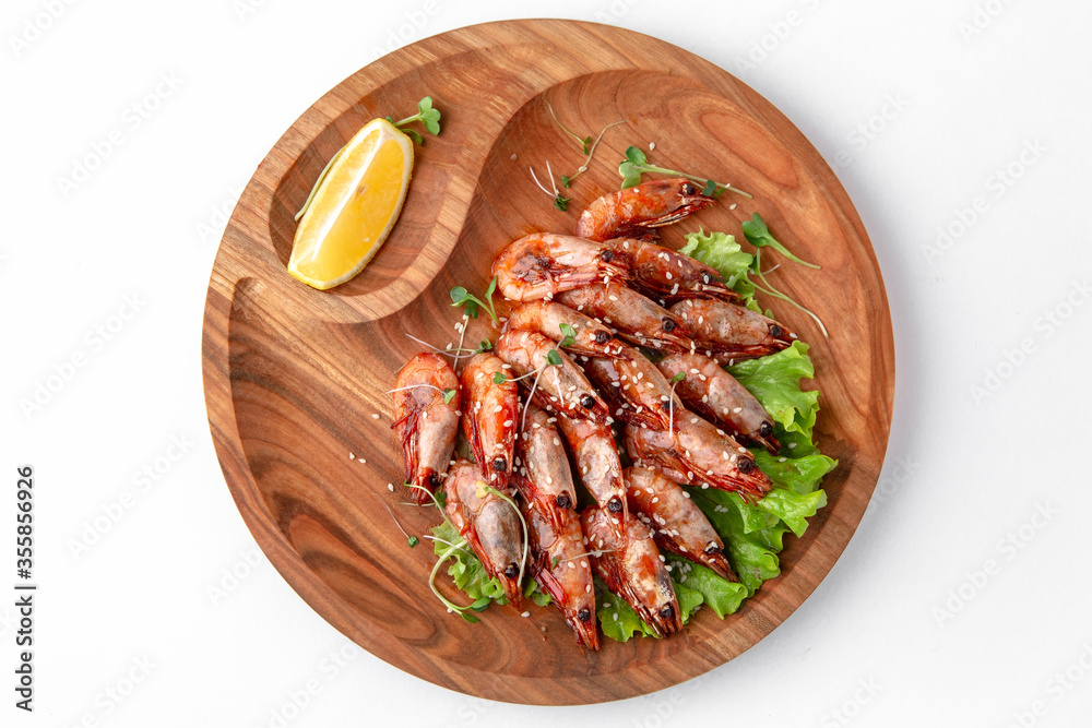 Prawns fried in soy sauce with garlic. Banquet festive dishes. Gourmet restaurant menu. White background.