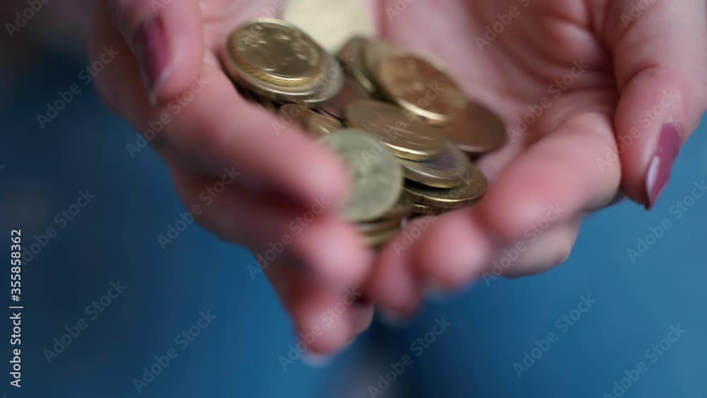 Shaking coins in person's hands, charity donation for low-income families. Close-up of coins money in hands, low earnings and financial problems. Person begging money, alms concept Shaking coins in person's hands, charity donation for low-income families. Close-up of coins money in hands, low earnings and financial problems. Person begging money, alms concept