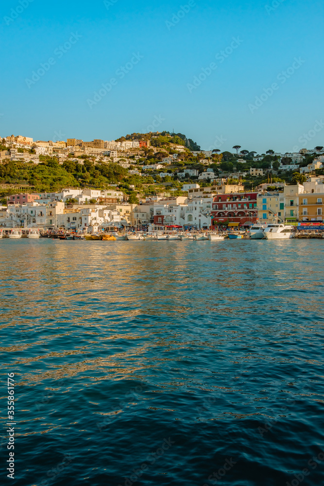 Fototapeta premium Capri harbor, full of colorful boats and houses.