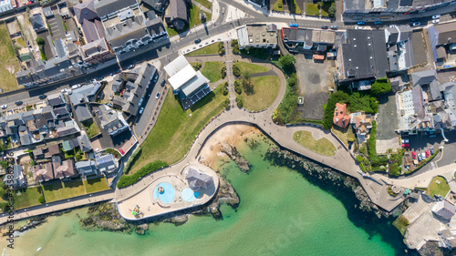 Aerial view on sandy Beach and coast of Atlantic Ocean in Portrush Northern Ireland, Top view on small coastal town 