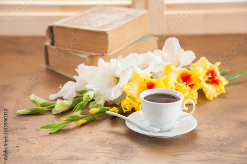 Fototapeta Naklejka Na Ścianę i Meble -  coffee and gladioluses on a table, selective focus