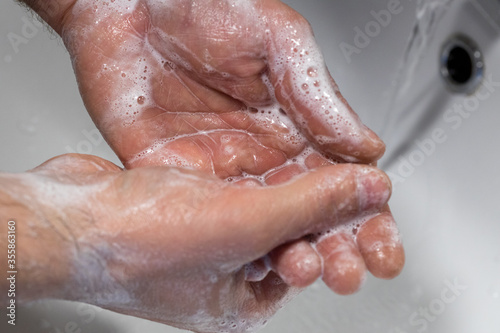 Soapy hands under the tap  Personal hygiene  Hand washing  Removal of viruses and bacteria  Basic protection against viruses and bacteria