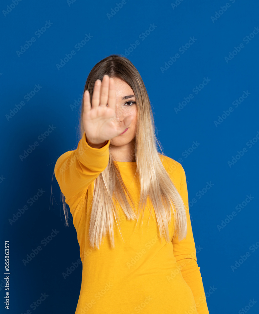 Blonde girl wearing a yellow T-shirt Blonde girl wearing a yellow T-shirt
