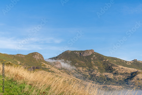 Silhouette of mountains in the misty morning. View of the mountains in early winter. Beautiful nature landscape. Bank Peninsula, Robinsons bay, Canterbury, Ndw Zealand.