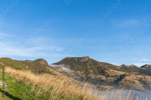 Silhouette of mountains in the misty morning. View of the mountains in early winter. Beautiful nature landscape. Bank Peninsula, Robinsons bay, Canterbury, Ndw Zealand.