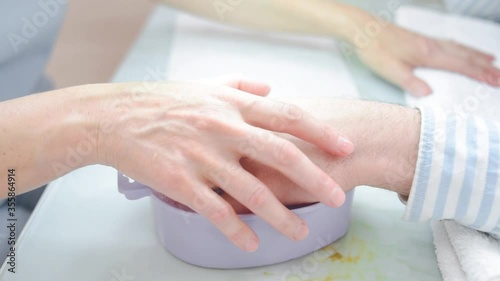 a manicurist saws a man's nails. High quality FullHD footage