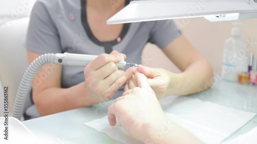 a manicurist saws a man's nails. High quality FullHD footage