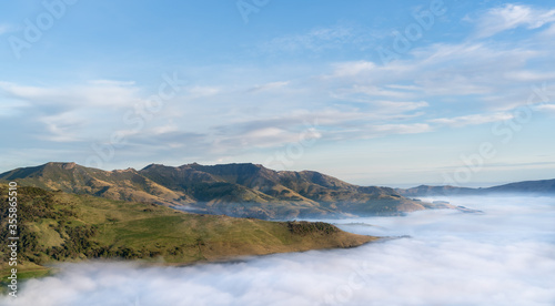 Silhouette of mountains in the misty morning. View of the mountains in early winter. Beautiful nature landscape. Bank Peninsula, Robinsons bay, Canterbury, Ndw Zealand.