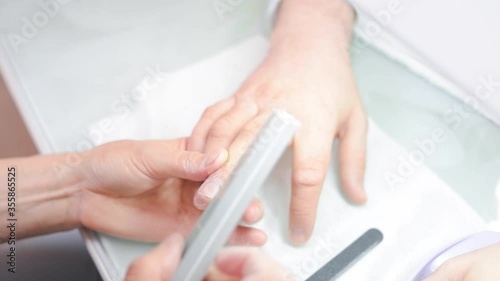 a manicurist saws a man's nails. High quality FullHD footage