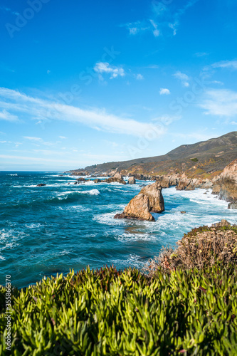 Beautiful landscape near Monterey city in California. Turquoise ocean with big waves and rocky cliffs photo