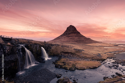 Man passing by Kirkjufell mountain during sunset - Iceland © Marcel