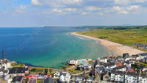 Aerial view on sandy Beach and coast of Atlantic Ocean in Portrush Northern Ireland, Top view on small coastal town  photo