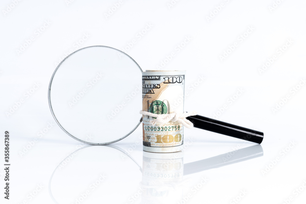 Magnifier glass and money with financial concept. Magnifier glass and money with financial concept.