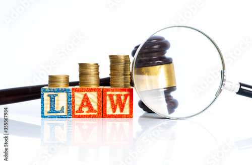 Magnifier glass and money with law concept.