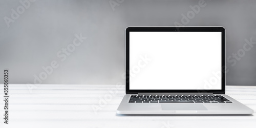 laptop mockup, home and office workspace concept. Laptop computer white blank screen on work table front view. Copy space photo
