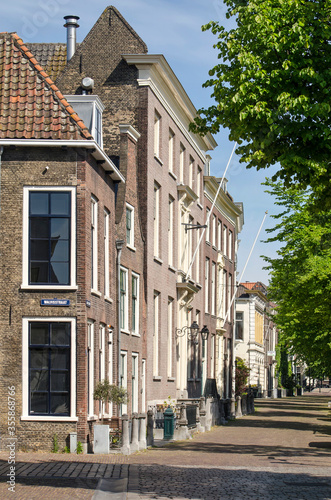 Schiedam, The Netherlands, May 18, 2020: traditional brick houses at the junction of Walisstraat and Lange Haven canal in the historic center of the gin capital © Frans