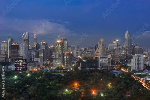 Aerial and panorama view of Bangkok skyscraper cityscape and park in twilight blue hour