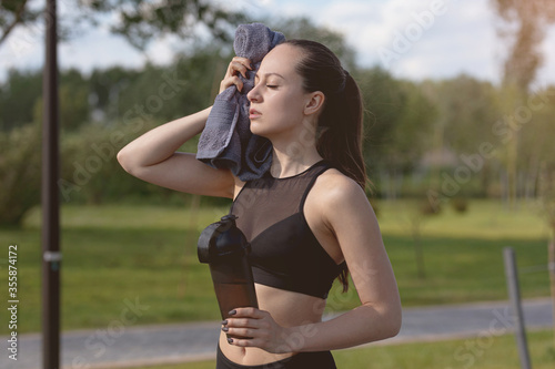 Fototapeta Naklejka Na Ścianę i Meble -  girl after jogging regains strength, healthy lifestyle concept