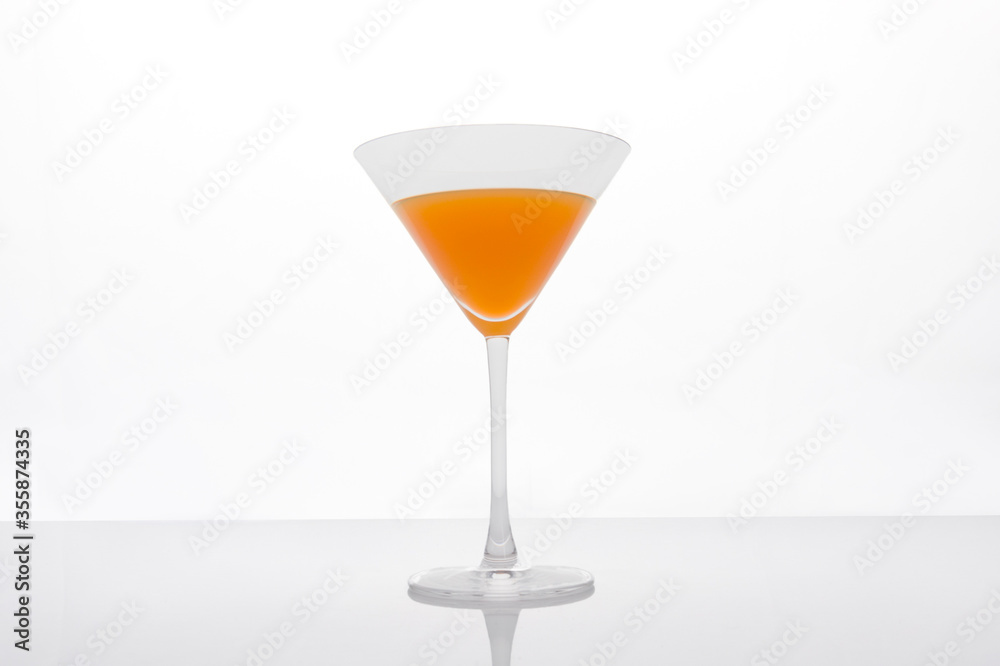 Cocktail glass with orange juice on white background Cocktail glass with orange juice on white background