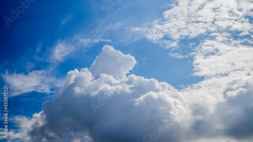 The blue sky and clouds gather on a bright day.