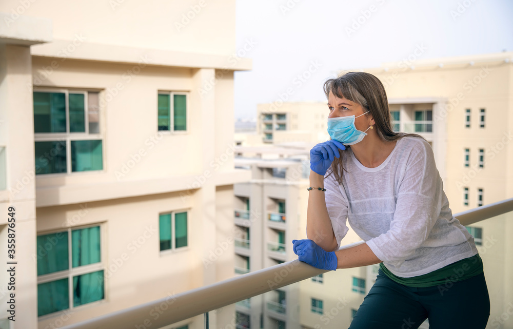 woman putting on rubber gloves during pandemic