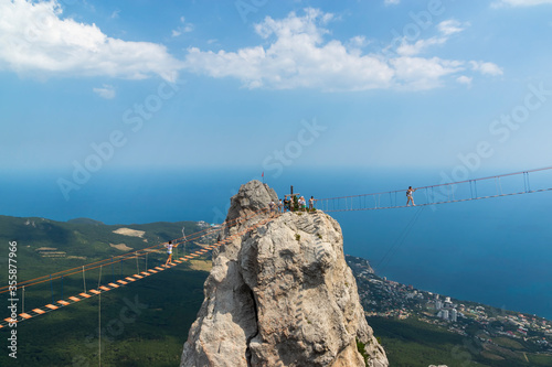 Suspension bridge on Mount Ai-Petri, Crimean Peninsula. Thrill attraction. Mountain peaks with sea view.