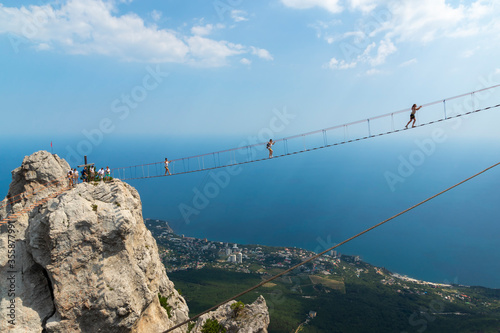 Obraz na płótnie Suspension bridge on Mount Ai-Petri, Crimean Peninsula. Thrill attraction. Mountain peaks with sea view. w salonie
