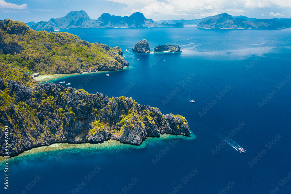 Aerial drone view of a tropical Mantiloc island coastline and open ocean. El Nido, Palawan island, Philippines