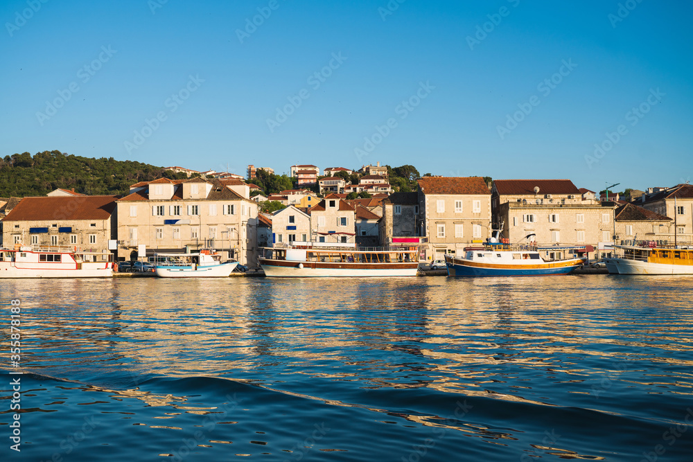 City by the sea in summer cityscape of Trogir town. Sunny morning seascape of Adriatic sea. Beautiful world of Mediterranean countries. Traveling concept background