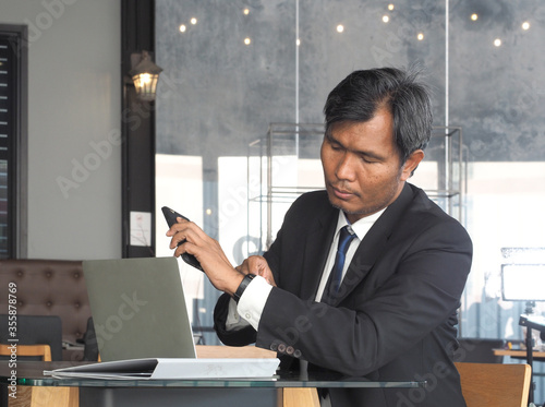 Asian business man seeing wristwatch to check time.Man look at clock to work.