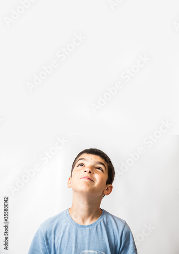 Boy looking up into a white blank background