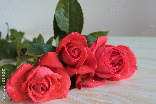 A bouquet of red roses is on the table.