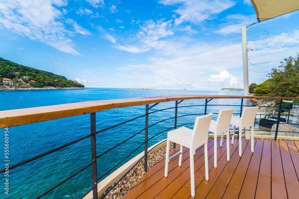 Chairs seats by the sea for guests to relax. Sea view seats in Dubrovnik, Croatia Chairs seats by the sea for guests to relax. Sea view seats in Dubrovnik, Croatia