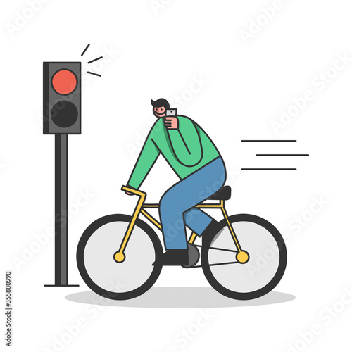 Man on bicycle riding on red light while speaking on mobile phone. Careless cyclist