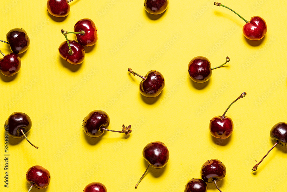 Bright summer wallpaper with ripe aromatic cherries on yellow background. Bright summer wallpaper with ripe aromatic cherries on yellow background.