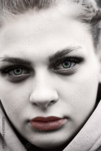 Dramatic portrait of a girl. Photographed close-up.