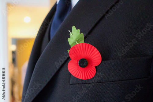 Red Poppy Pinned on to Suit Jacket - Remembrance Day