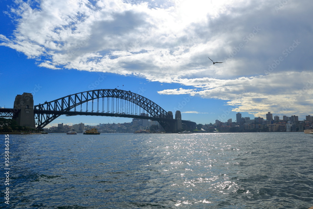 Obraz premium Sydney, Australia - July 16, 2014; Sydney harbor bridge view on a beautiful day.