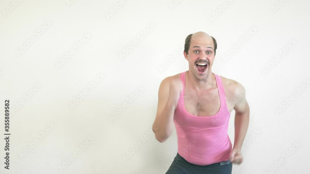 handsome cheerful balding man goes in for sports at home handsome cheerful balding man goes in for sports at home