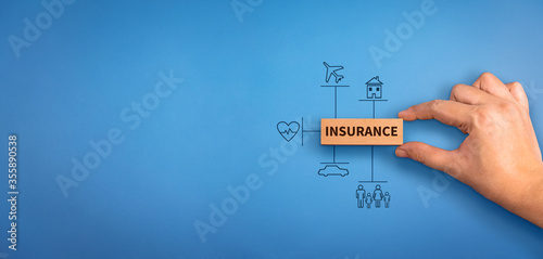 Cuadro en lienzo hand holding a wooden block with text insurance, different type of insurance icons