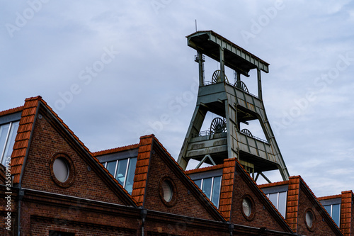 View of the disused coal mine Ewald in the Ruhr area in Germany with houses in front