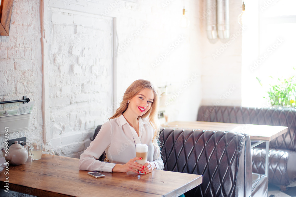 Young woman holding cup of coffee. Young woman holding cup of coffee.