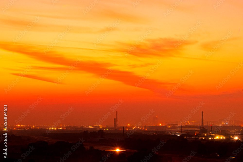 Colorful dramatic sunset sky in an industrial zone of a city.