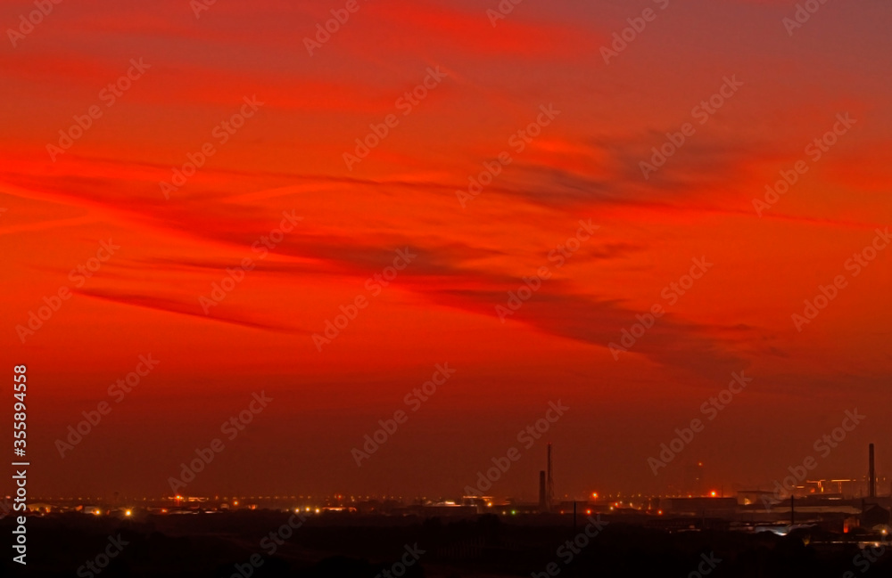 Colorful dramatic sunset sky in an industrial zone of a city.