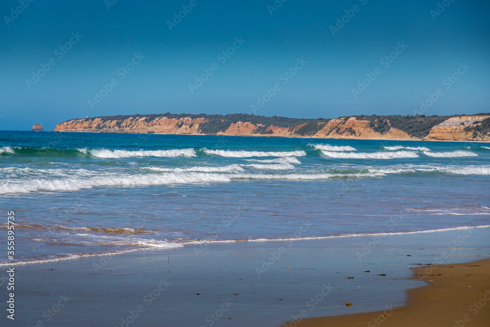 Traveling along the Great Ocean Road in New South Wales, Australia, visiting  a beach next to the Seven Miles Beach National Park at a sunny day in summer.