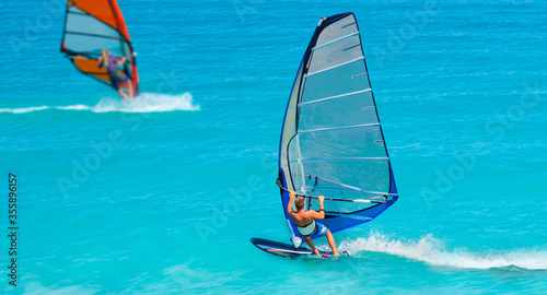 Bild auf Leinwand Beautiful cloudy sky with (same) Windsurfer Surfing The Wind On Waves In Alacati