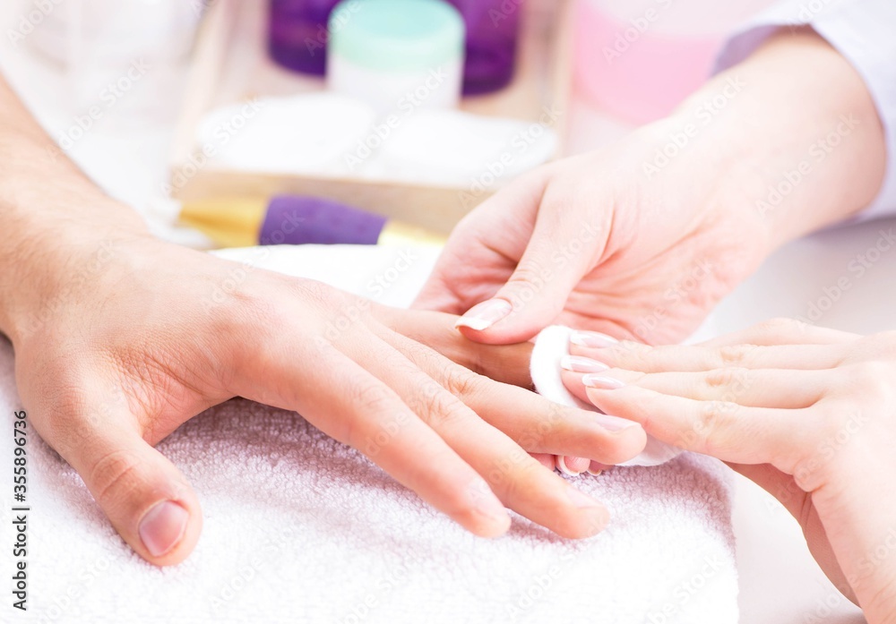 Naklejka premium Hands during manicure care session